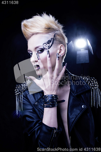 Image of Fashion Rocker Style Model Girl Portrait. Hairstyle. Rocker or Punk Woman Makeup, Hairdo and black Nails. Smoky Eyes in studio