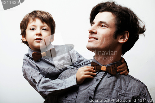 Image of father with son in bowties on white background, casual look