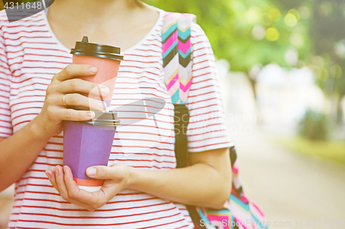 Image of Take-away coffee in his hands.