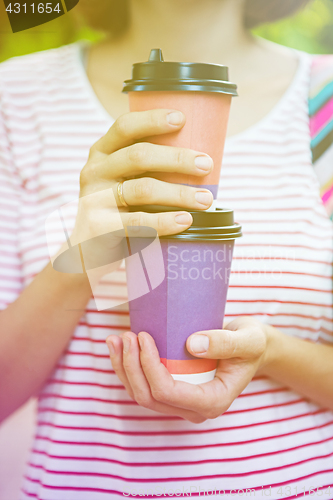 Image of Take-away coffee in his hands.