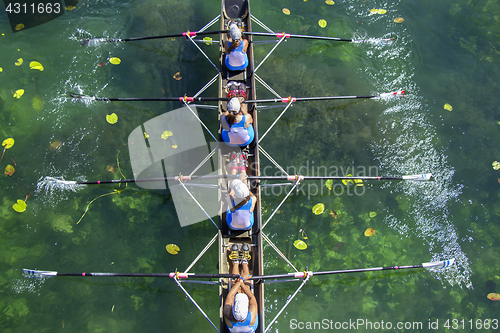 Image of Ladies fours rowing team in race on the lake