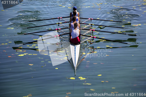 Image of Males fours rowing team in race on the lake