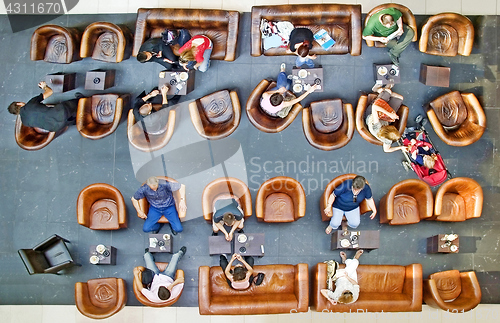 Image of High angle view of people on the break coffee In Coffee Shop