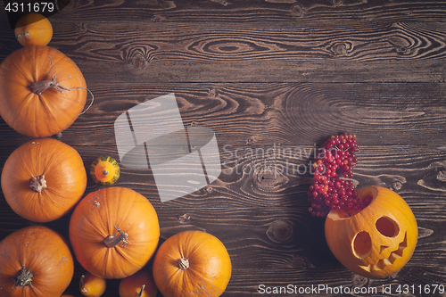 Image of Halloween pumpkins over wooden background
