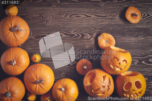 Image of Halloween pumpkin over wooden background