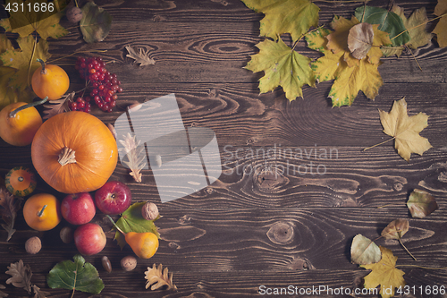 Image of Ripe yellow pumpkins over wooden background