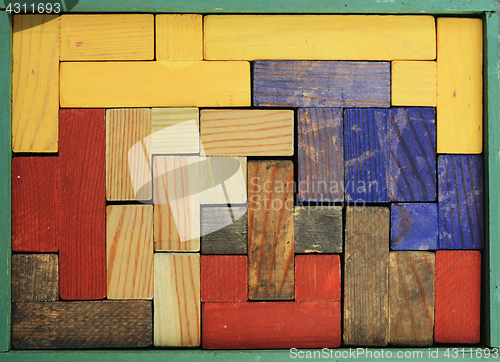 Image of old wooden multicolored puzzle in box