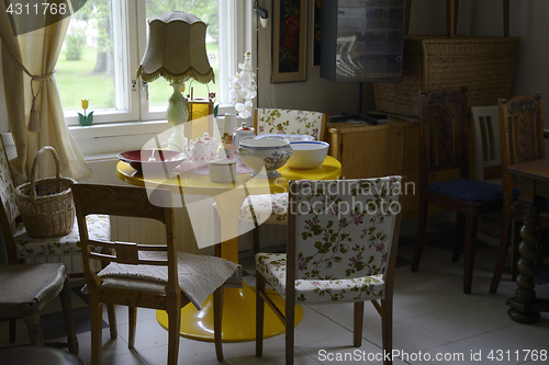 Image of small cozy room filled with furniture and utensils