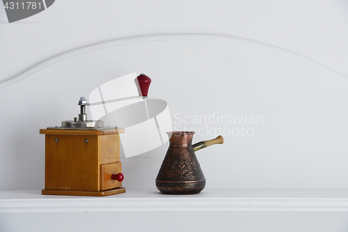 Image of vintage hand coffee grinder and old arabic coffee pot 