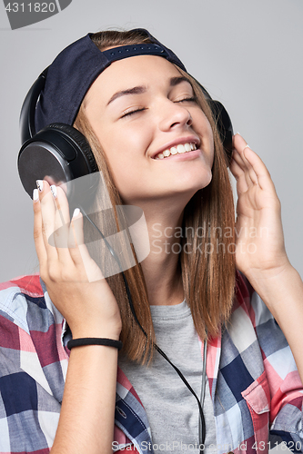 Image of Teen girl listening enjoying music