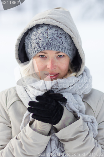 Image of Portrait of lady outdoor in snow in cold winter time.