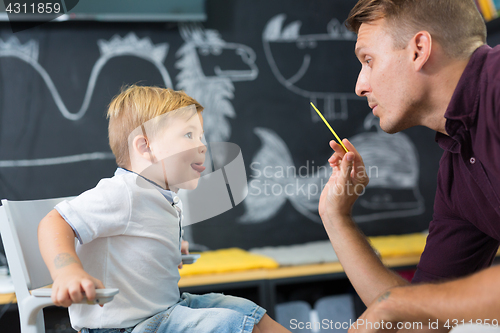 Image of Cute little boy at speechtherapist session.