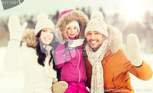 Image of happy family waving hands outdoors in winter