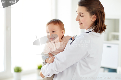 Image of doctor or pediatrician holding baby at clinic