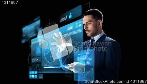 Image of businessman with tablet pc and virtual screen