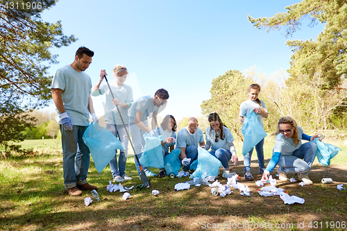 Image of volunteers with garbage bags cleaning park area