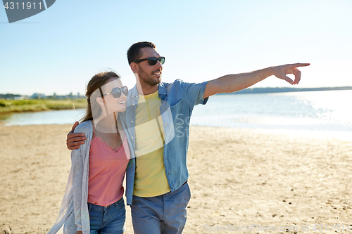 Image of happy couple hugging on summer beach