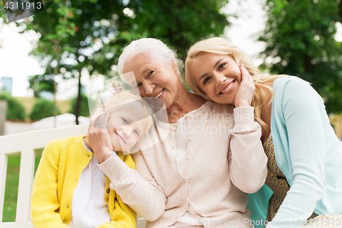 Image of woman with daughter and senior mother at park