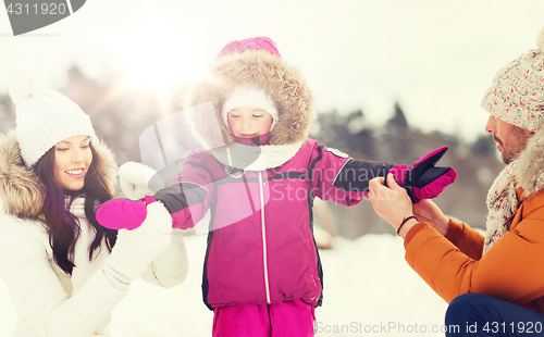 Image of happy family with child in winter clothes outdoors