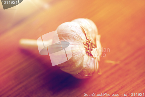 Image of close up of garlic on wooden table