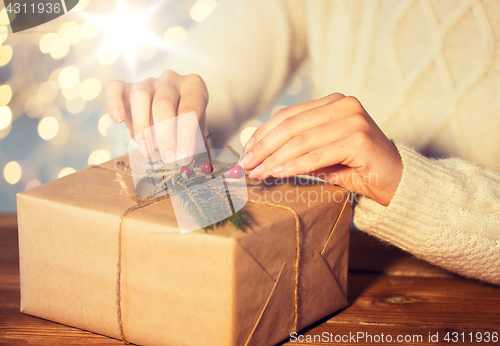 Image of close up of woman with christmas gift or parcel