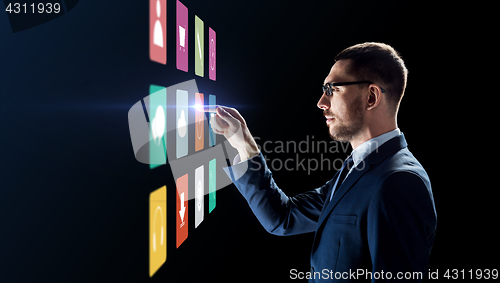 Image of businessman with menu icons on virtual screen