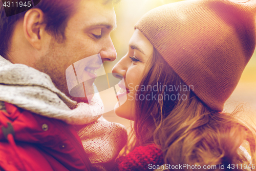 Image of close up of happy young couple kissing outdoors