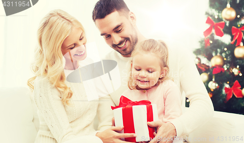 Image of happy family at home with christmas gift box