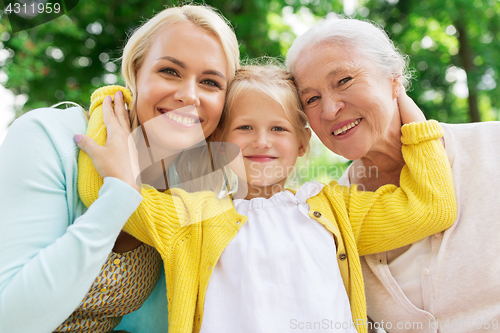 Image of woman with daughter and senior mother at park