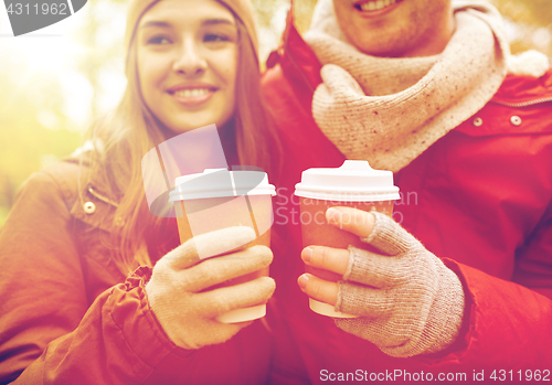 Image of close up of happy couple with coffee in autumn