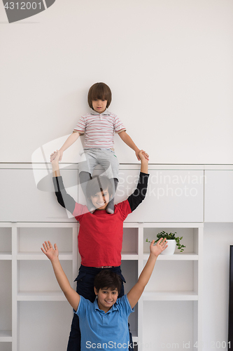 Image of young boys posing line up piggyback