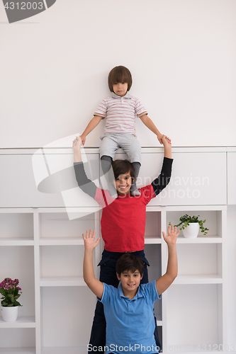 Image of young boys posing line up piggyback