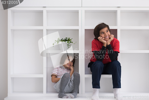 Image of young boys posing on a shelf