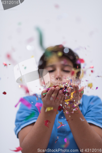 Image of kid blowing confetti