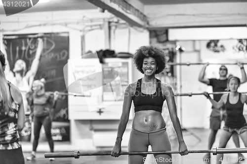 Image of black woman lifting empty bar