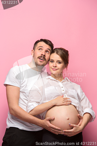 Image of The handsome man and his beautiful pregnant wife\'s tummy