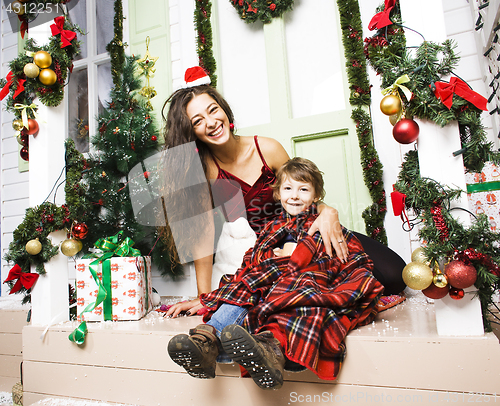 Image of happy family on Christmas in red hats waiting gests and smiling