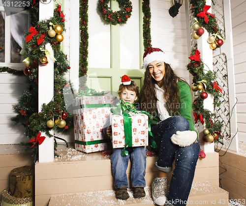 Image of happy family on Christmas in red hats