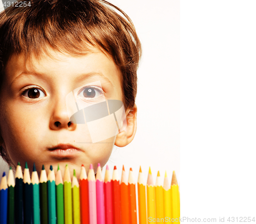 Image of little cute boy with color pencils close up smiling