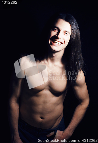 Image of handsome young man with long hair naked torso on black background