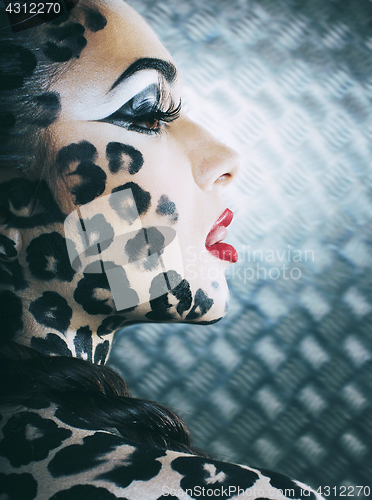 Image of young sexy woman with leopard make up all over body, cat bodyart