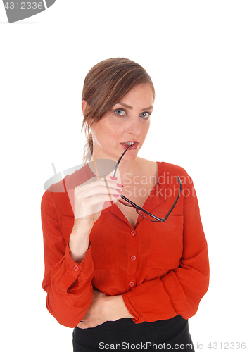 Image of Business woman with glasses in mouth.