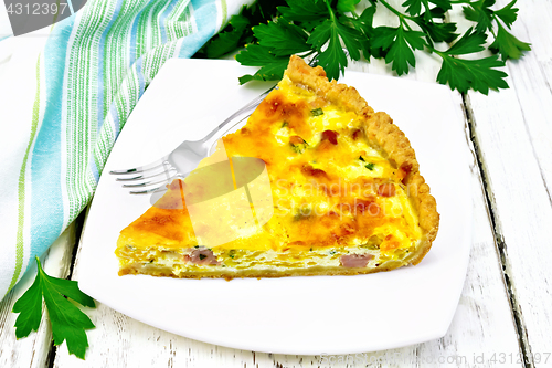 Image of Quiche with pumpkin and bacon in white plate on wooden board