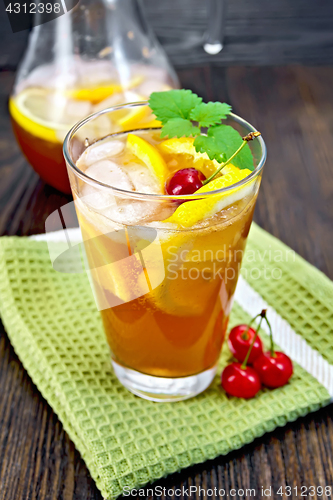 Image of Lemonade cherry and orange in glassful on dark board