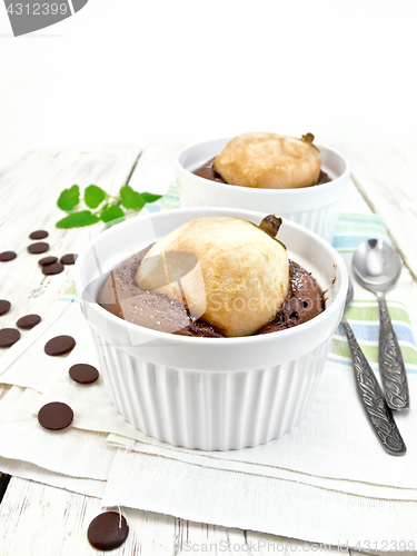 Image of Cake with chocolate and pear in white bowl light board
