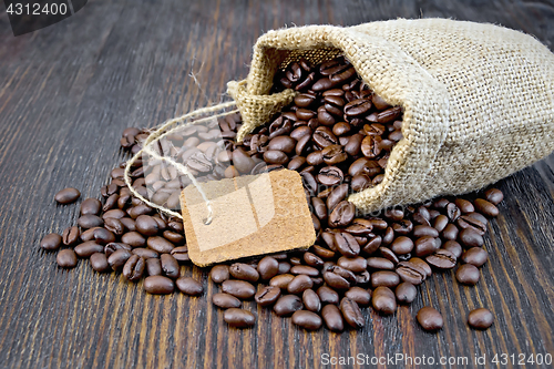 Image of Coffee black grain with tag in bag on board