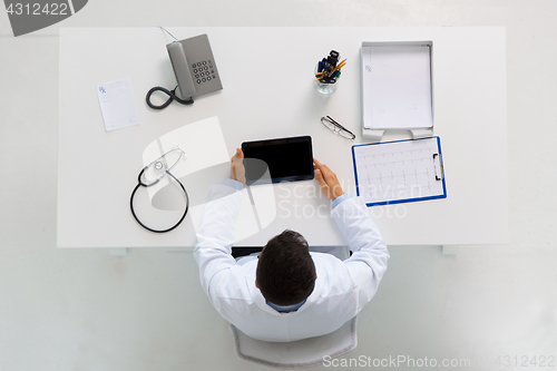 Image of doctor with tablet pc and cardiogram at clinic