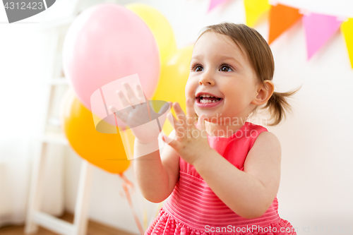 Image of happy baby girl on birthday party at home