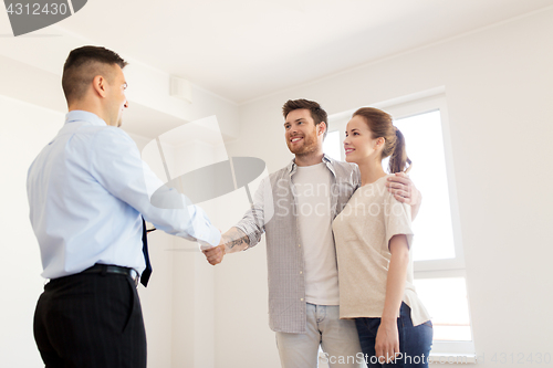 Image of man and realtor shaking hands at new home