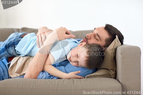 Image of happy father and son sleeping on sofa at home